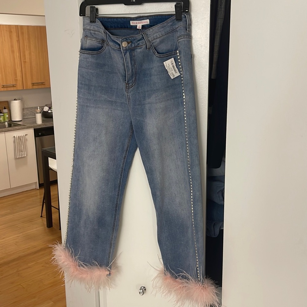 Jeans with rhinestone and feather detail